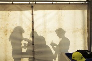 A silhouette of performers getting ready backstage. Portolan, Sunderland Tall Ships, Cirque Bijou. Image Dan Prince.