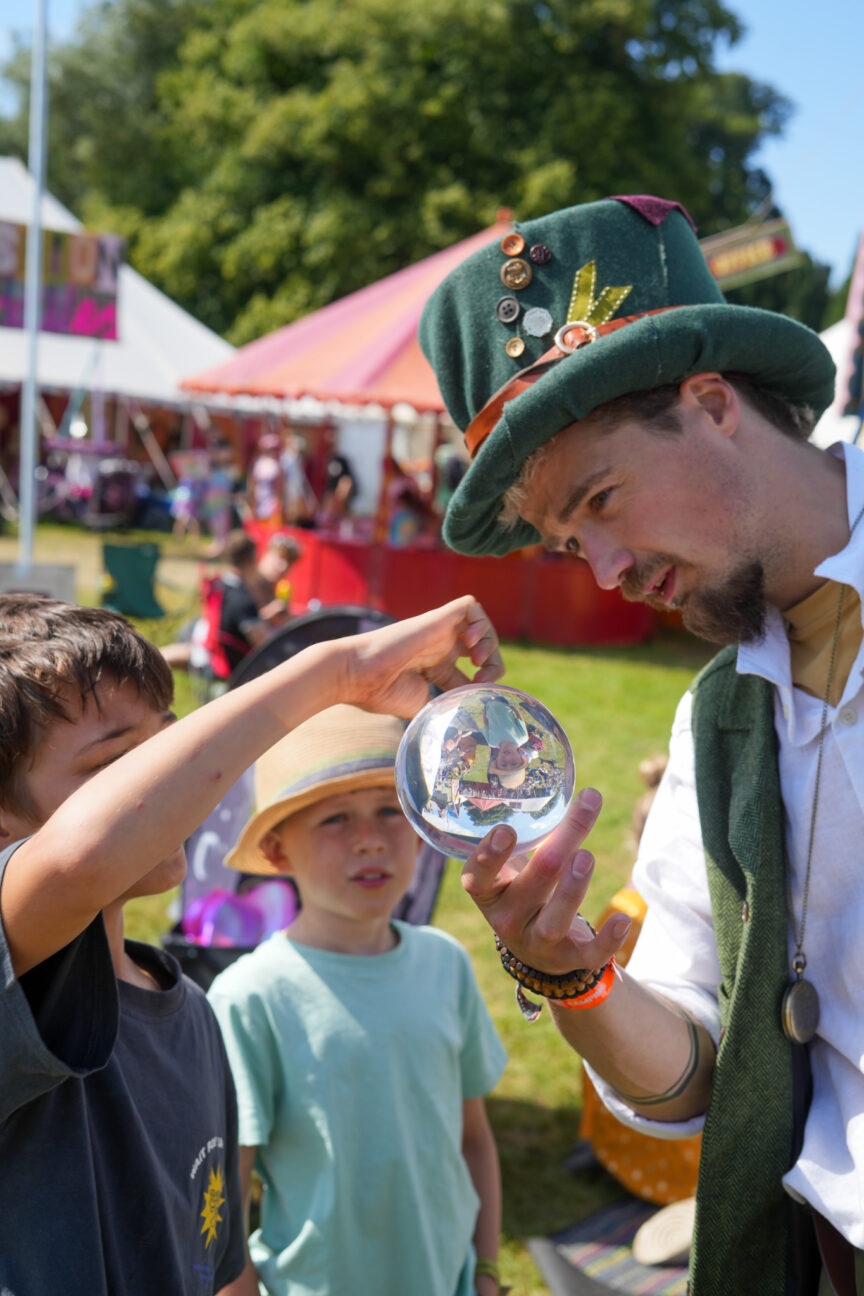 Camp Bestival Navigator showing some children their crystal ball skills