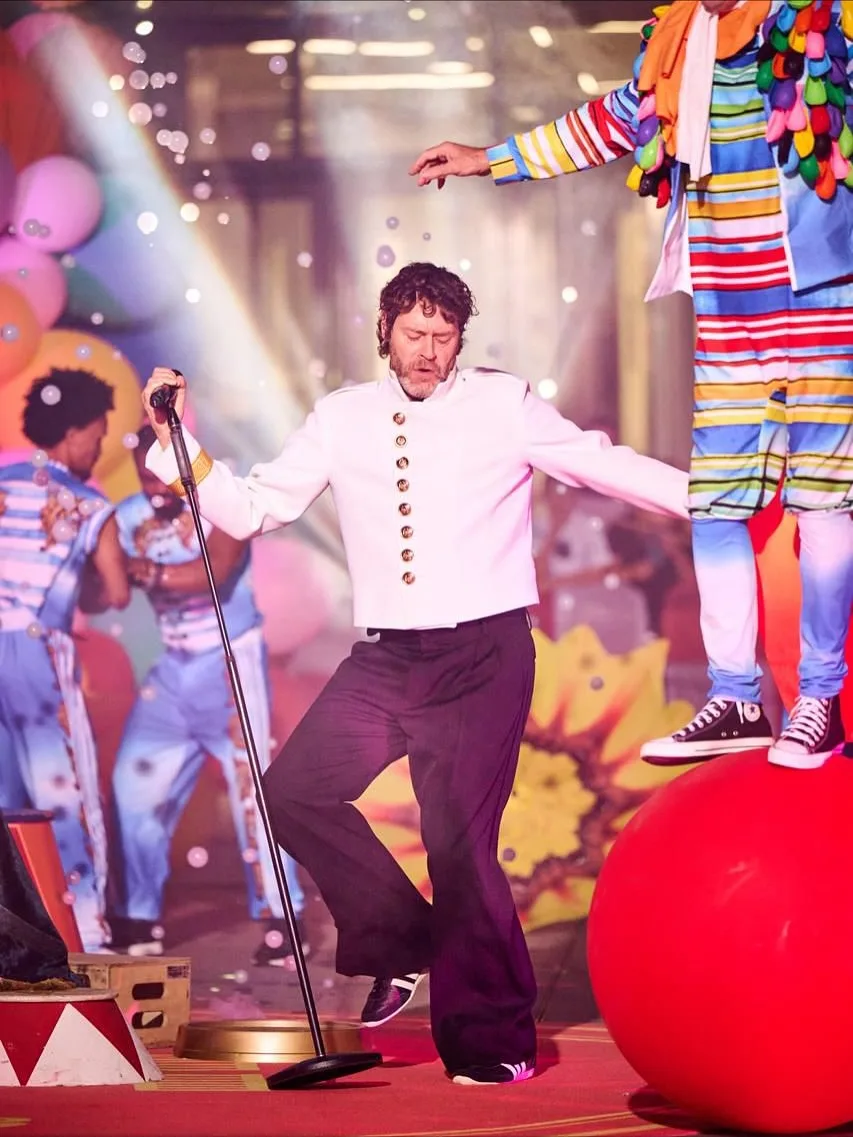 Take That performing surrounded by circus artists