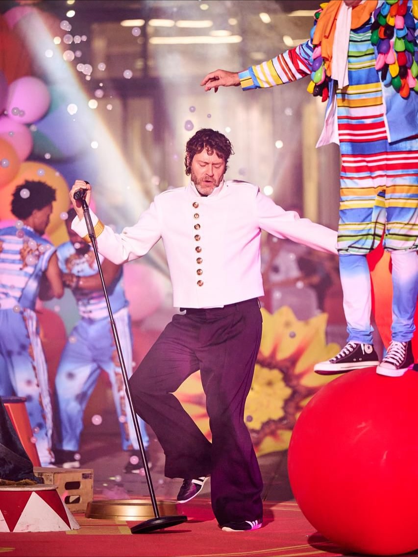 Take That performing surrounded by circus artists