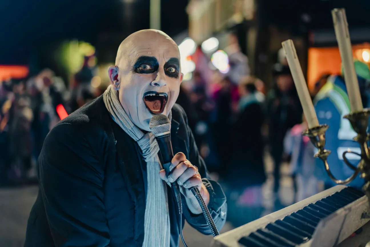 Uncle Fester on a motorised piano with microphone in the parade