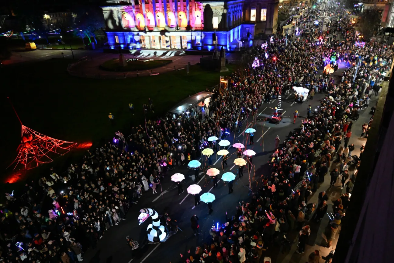 Wide shot of the parade from above showing the light up umbrellas