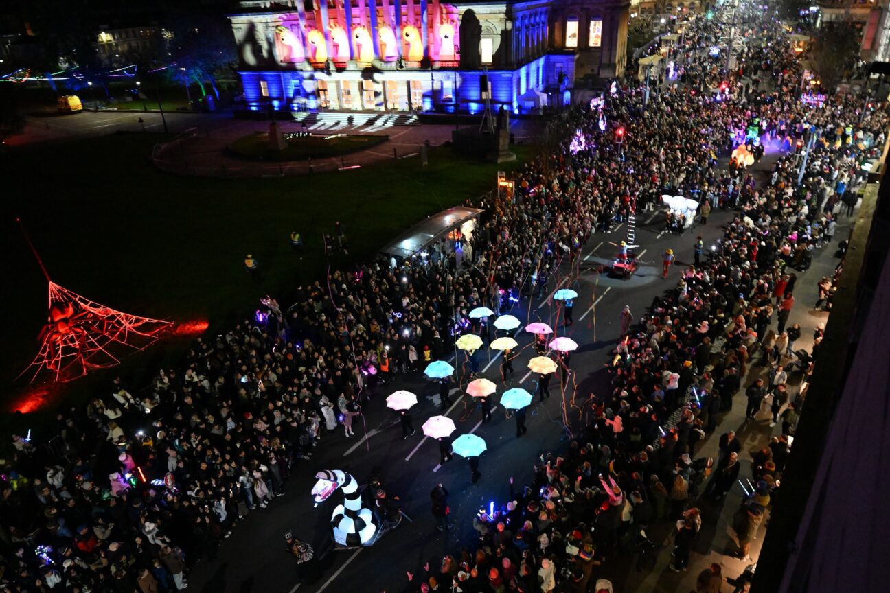 Wide shot of the parade from above showing the light up umbrellas