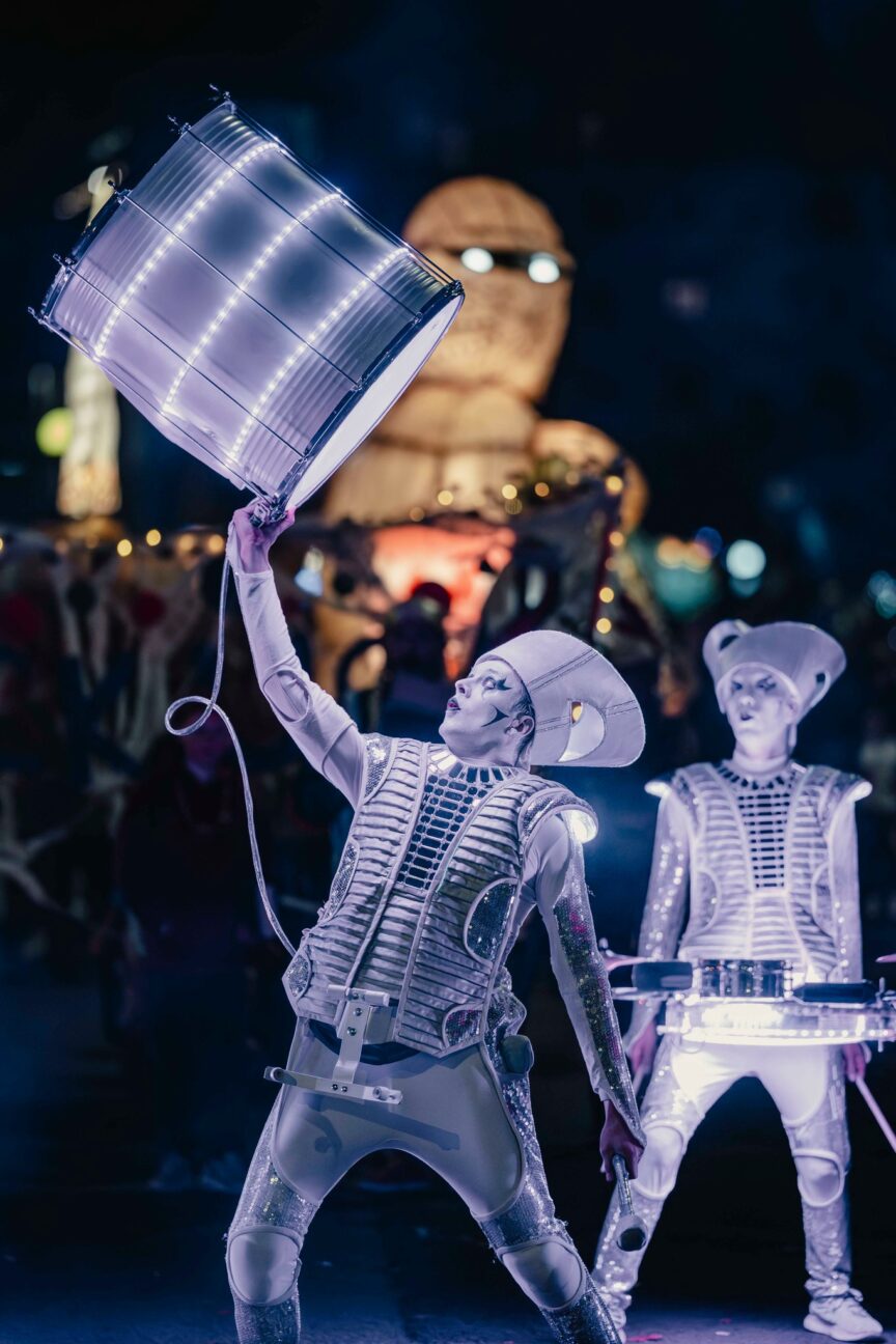 ghostly space age drummer holding light up drum