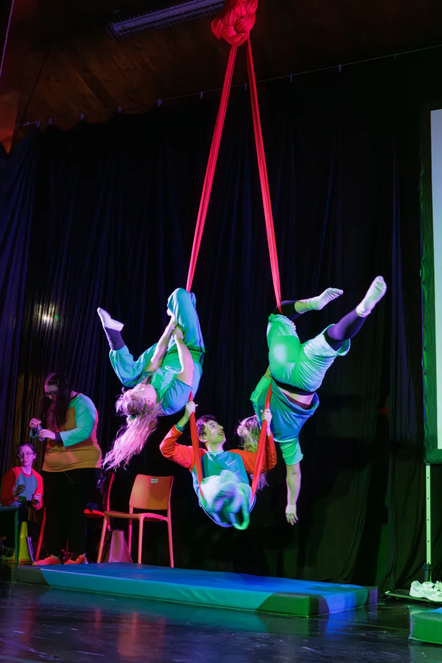 three performers on aerial silks at the same time