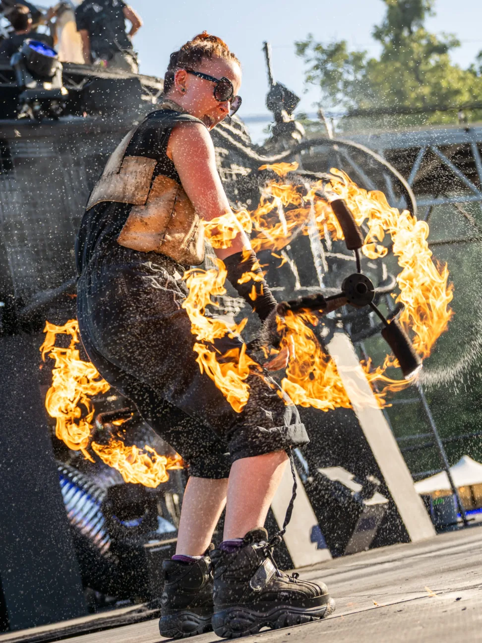 A post apocalyptic warrior spinning a fire staff.