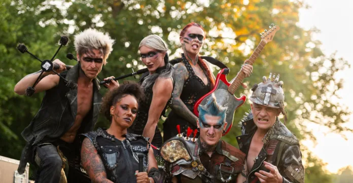 A group of punk styled post apocalyptic outlaws posing to camera