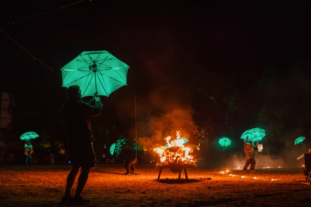 Wide shot of lots of performers with our LED Umbrellas all glowing green 